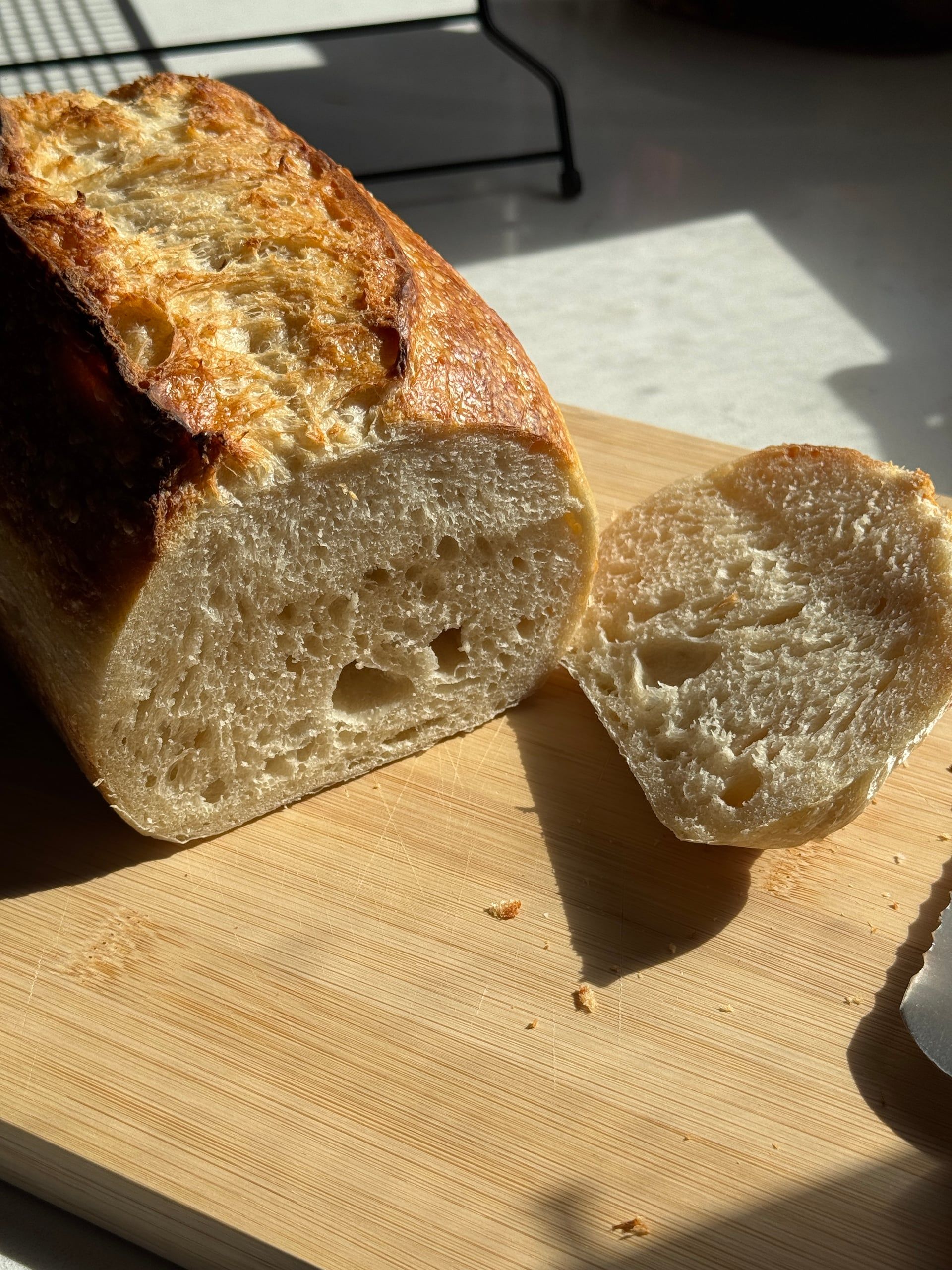 Sliced sourdough loaf showing an open, airy crumb
